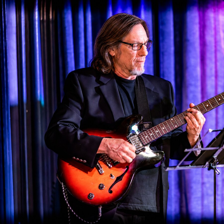 Mike Ernst performing live on guitar for What the World Needs Now